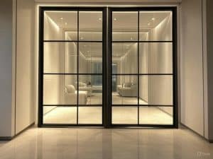 Luxurious wine cellar entrance with double interior metal doors with glass, enhancing modern home aesthetics